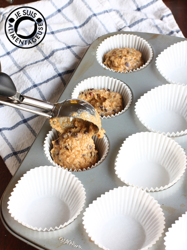 Scooping the batter into the muffin tins | Pumpkin Chocolate Chip Muffins | alimentageuse.com #pumpkin #fall #chocolate #vegan