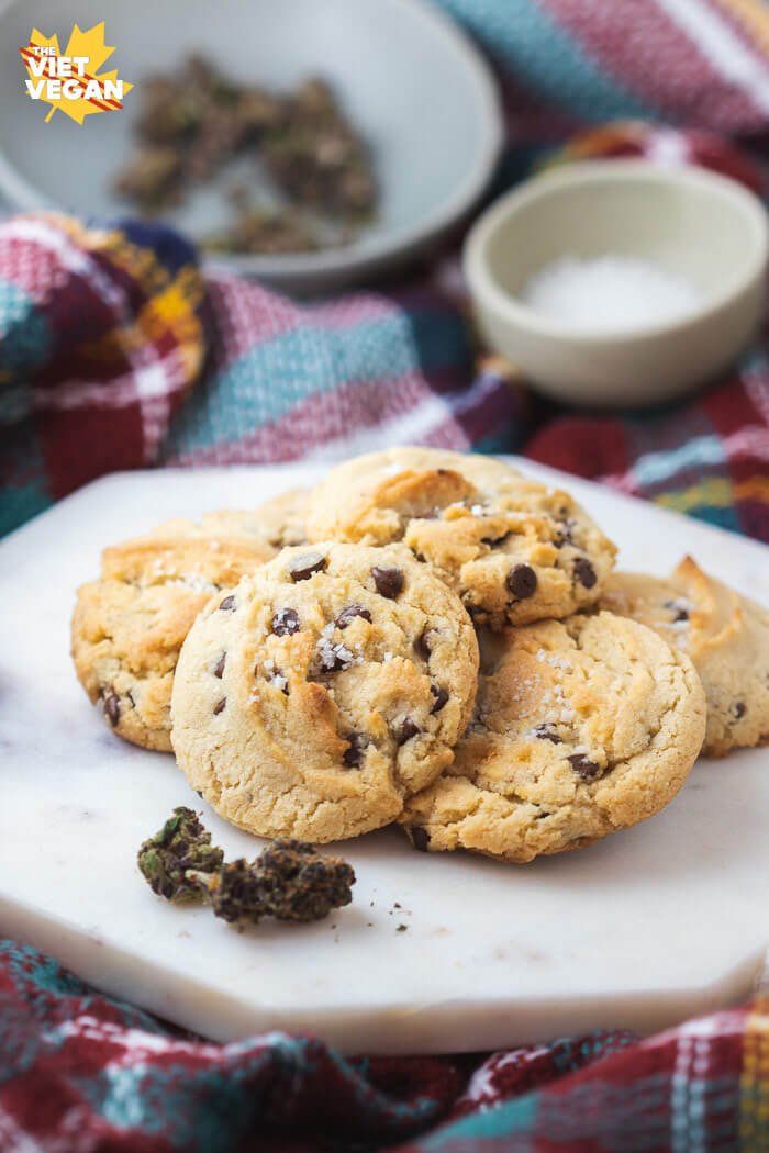 vegan cannabutter cookies on a marble slab with marijuana in front