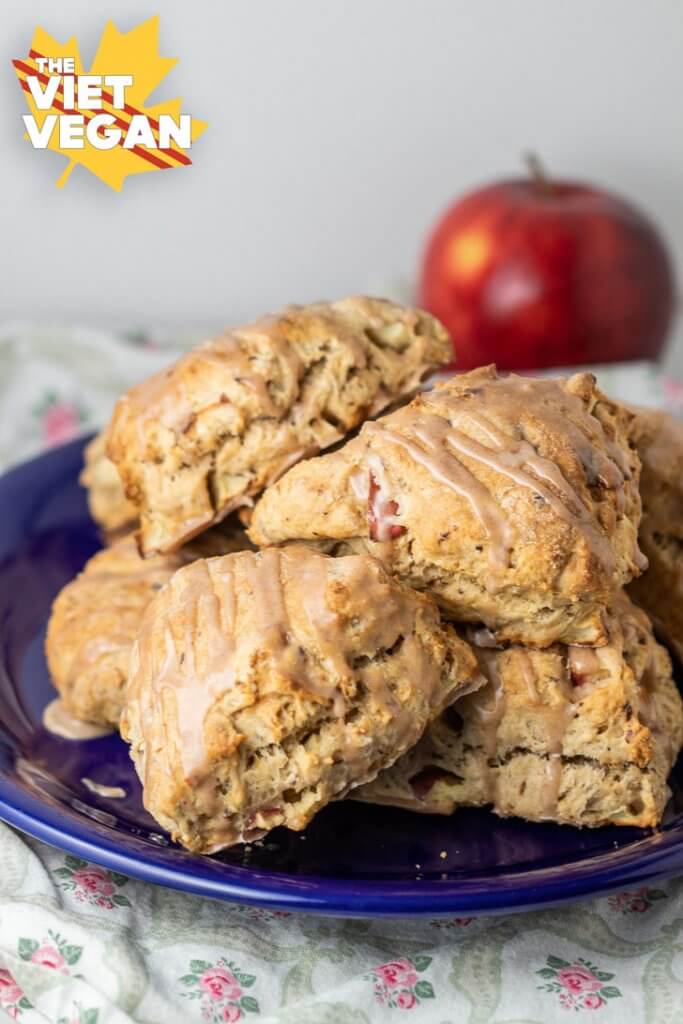 A pile of frosted scones on a plate