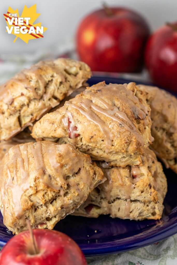 A pile of frosted scones on a plate