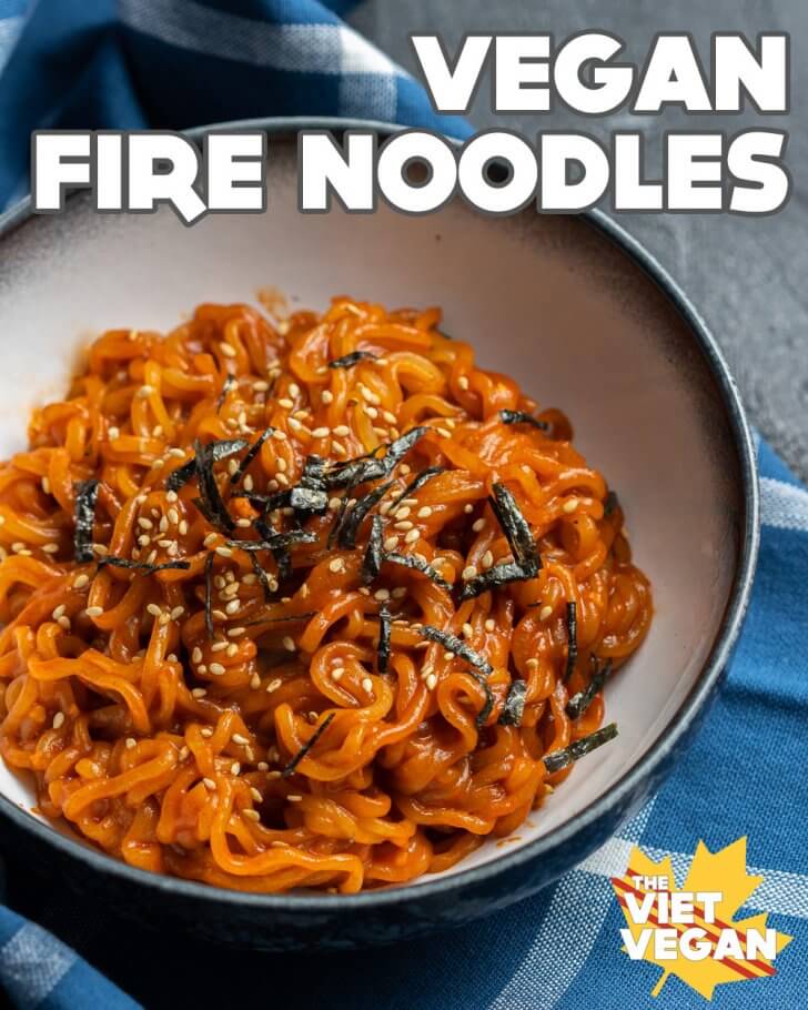 red ramen noodles topped with sesame and nori in a bowl, overhead