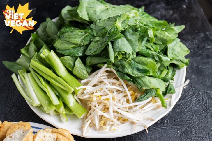 mung bean sprouts, yu choy and pea shoots, on a plate