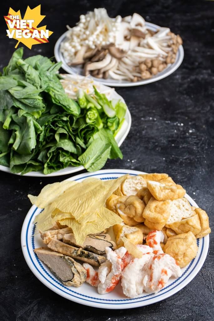 three plates of hot pot ingredients in a row