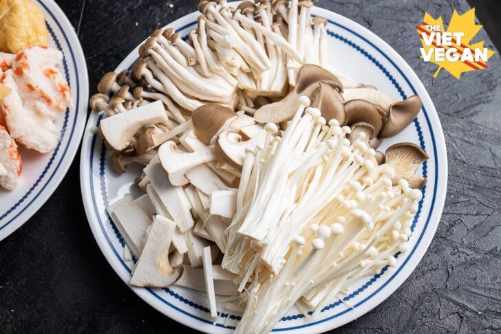 a variety of mushrooms: enoki, shimeji, king oyster and black oyster