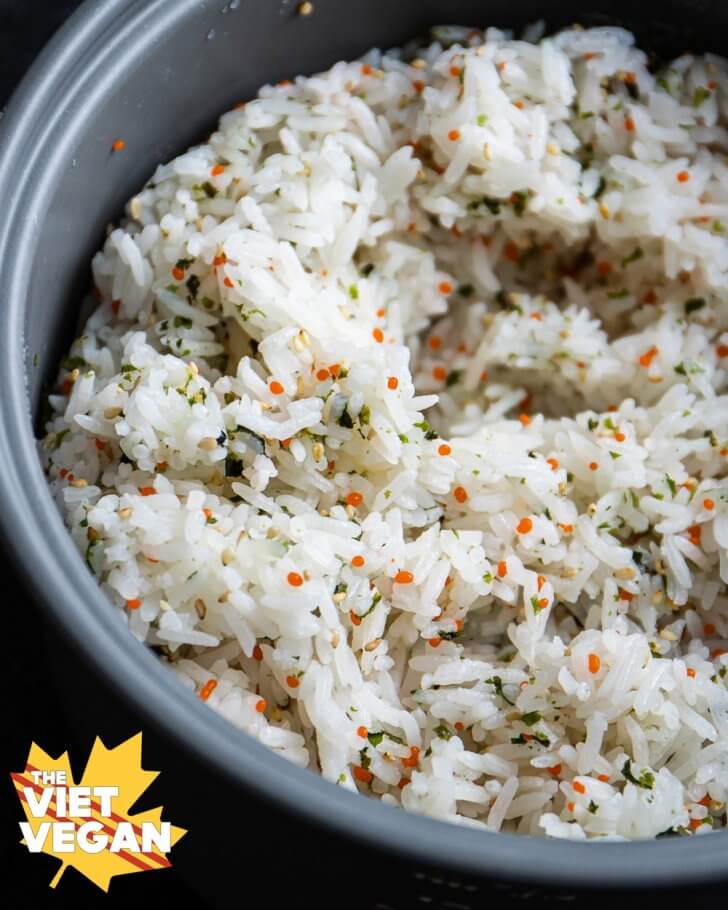 rice mixture in the steamer pot with vegan seaweed pearls and furikake