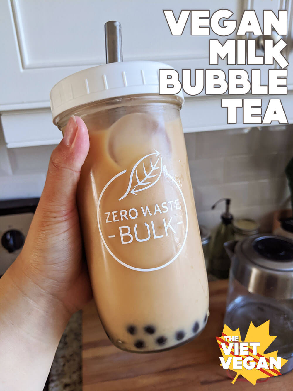 bubble tea in a tall 16oz jar with a white lid and metal straw