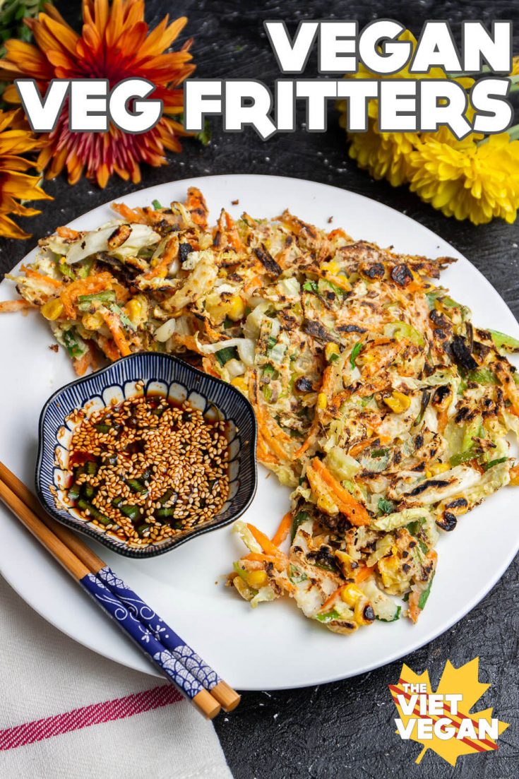 Text overlay on a photo of Vegan vegetable fritters on a plate with dipping sauce, surrounded by autumn flowers (dahlias)