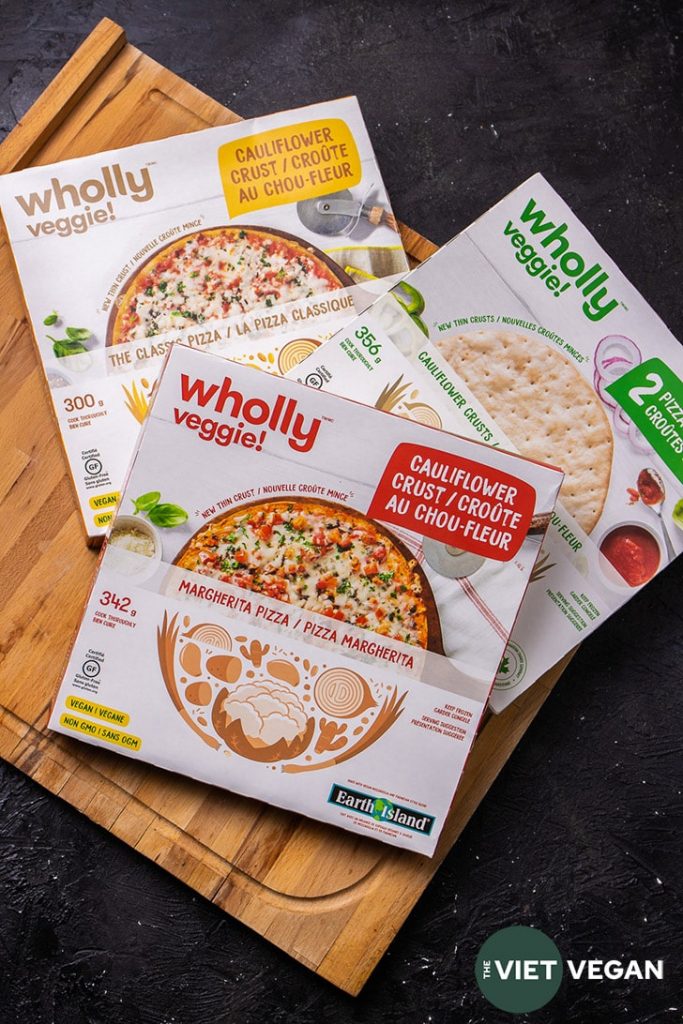 Three boxes of Wholly Veggie Pizza, in classic cheeze flavour, margherita flavour, and two naked cauliflower crusts