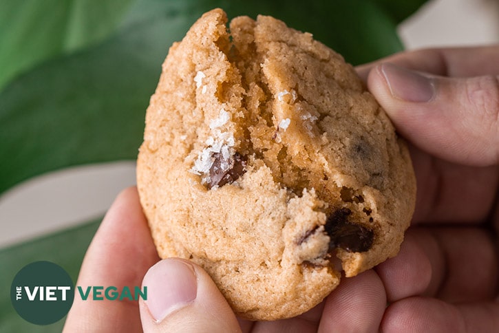 broken cookie to show soft, chewy interior of chocolate chip cookies