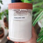 dry vegan pancake mix in a tub with "pancake mix" label on it