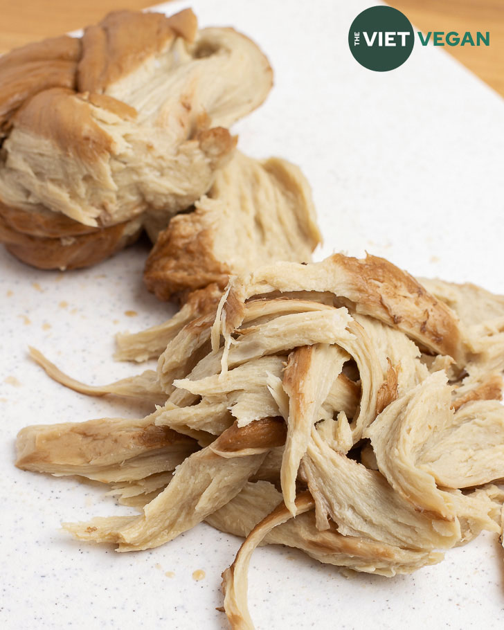 washed flour seitan pulled apart to show texture on a cutting board