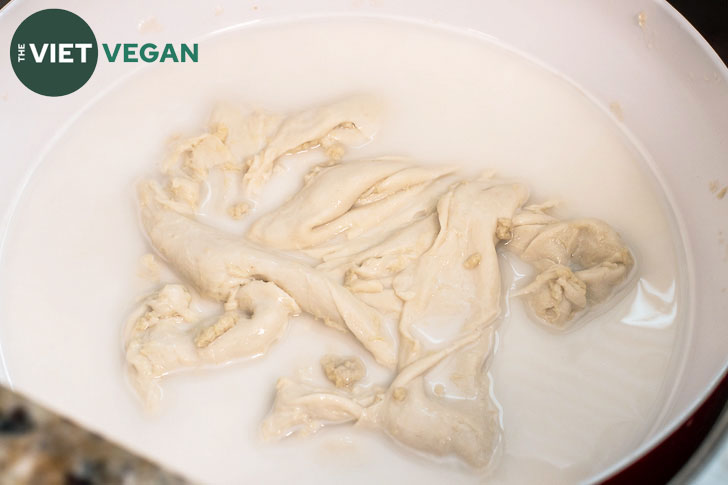 Beginnings of washed flour seitan--the dough sitting in starchy water in a large mixing bowl