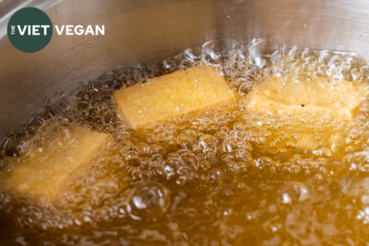 tofu frying in a pot of oil