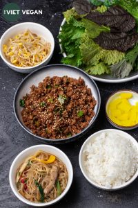 ingredients for ssam with bulgogi ground, japchae, kongnamul muchim, rice and pickled radish in bowls