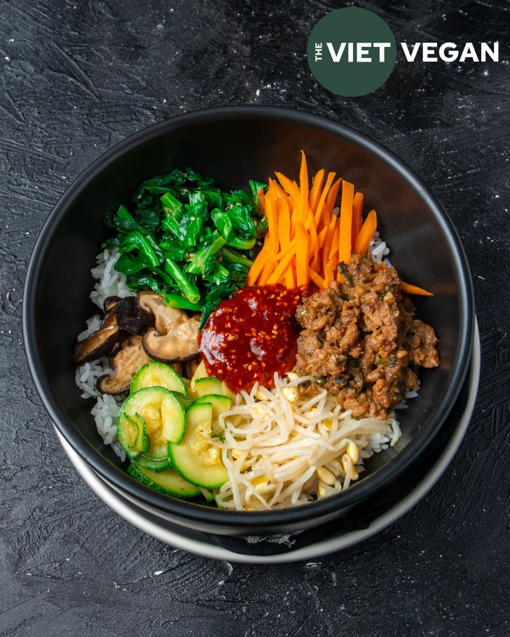 Overhead shot of dolsot bibimbap (rice with vegetable side dishes arranged on top)