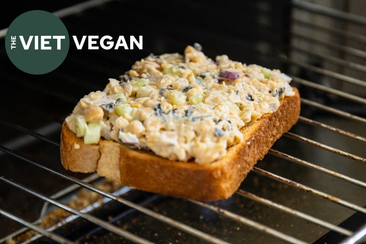 vegan tuna melt mixture on a piece of toast before adding cheese