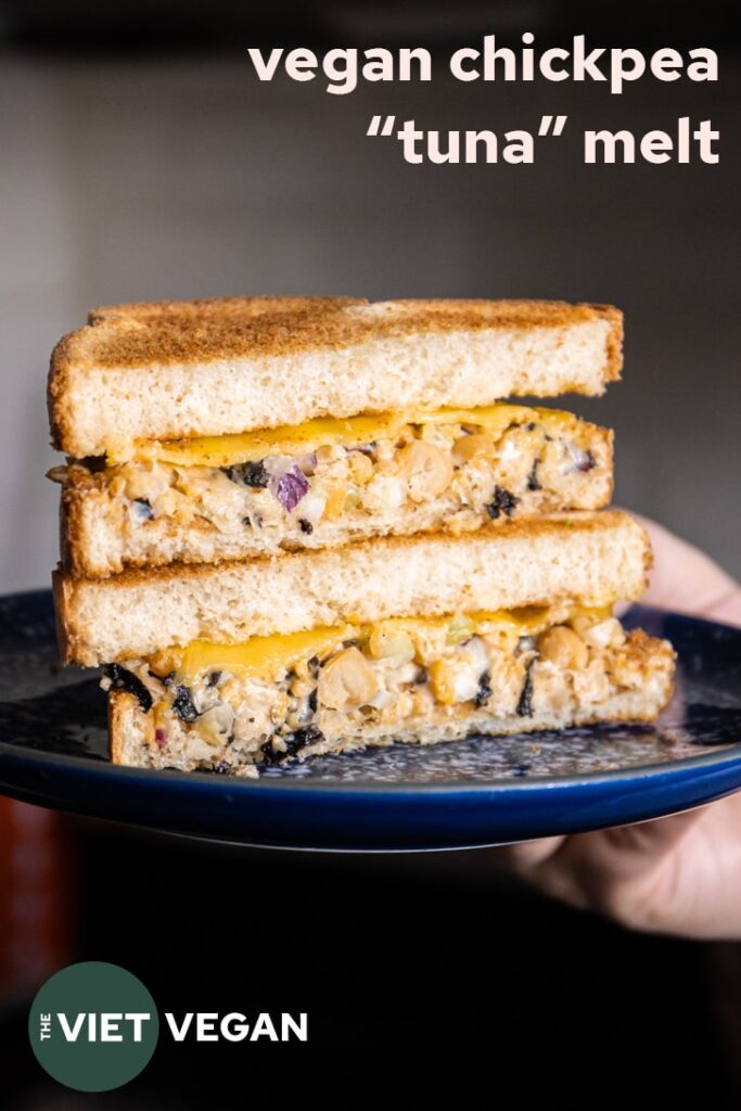 chickpea tuna melt cut in half and stacked on a blue speckled plate