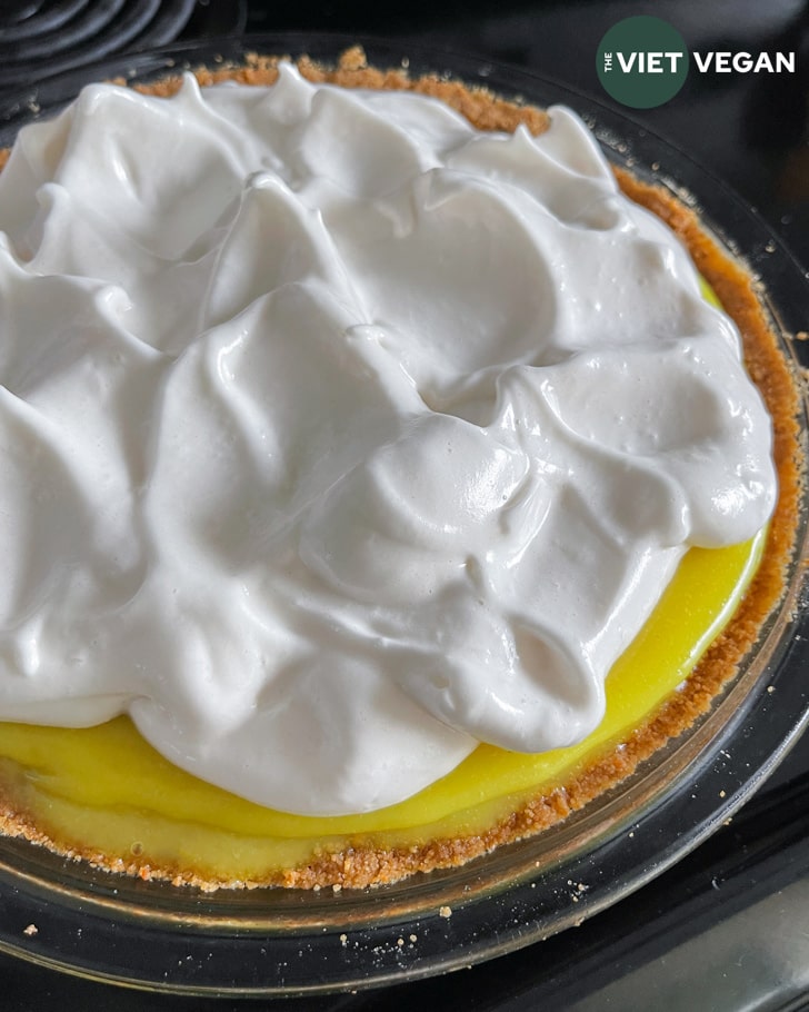 Adding meringue to the pie before toasting