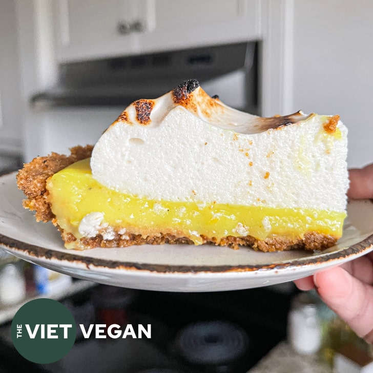 Slice of vegan lemon meringue pie, showing texture of the meringue