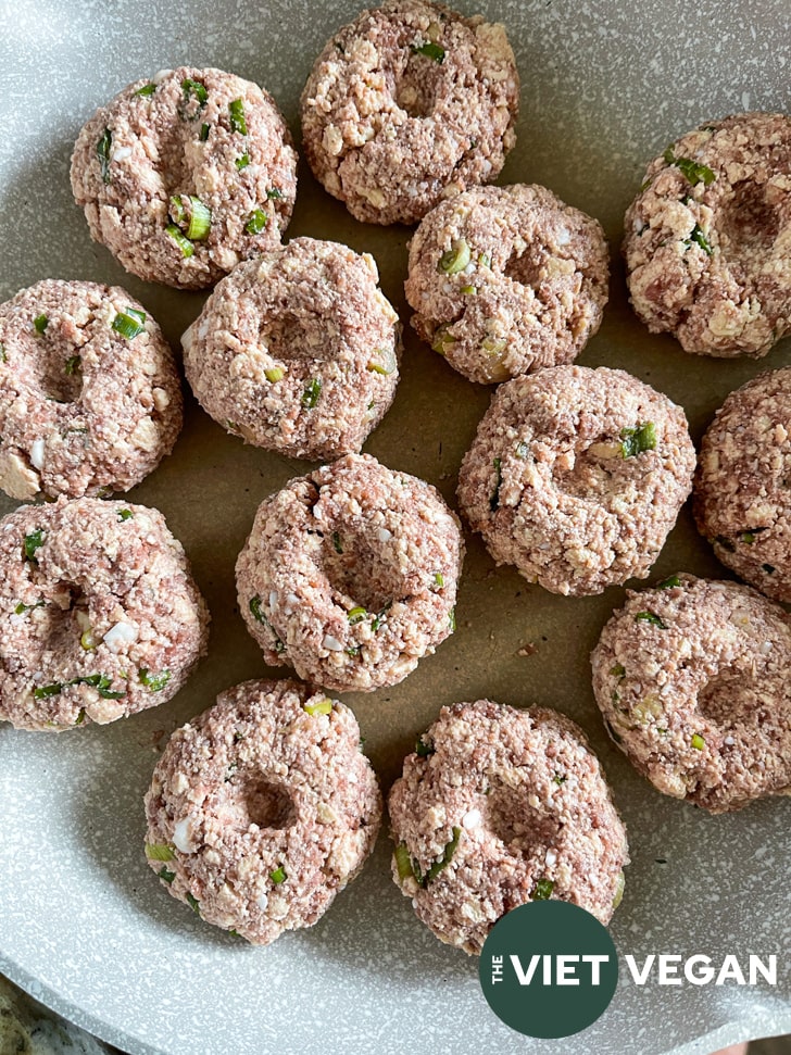 dimpled tofu hamburger steaks in a pan