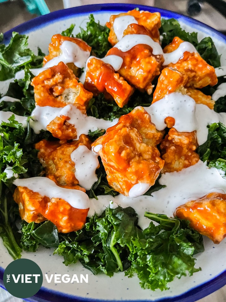 buffalo ranch tofu on a bed of massaged kale