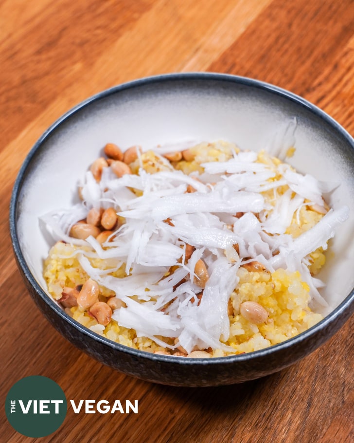 Sticky rice in a bowl with peanuts, sesame seeds and fresh coconut meat