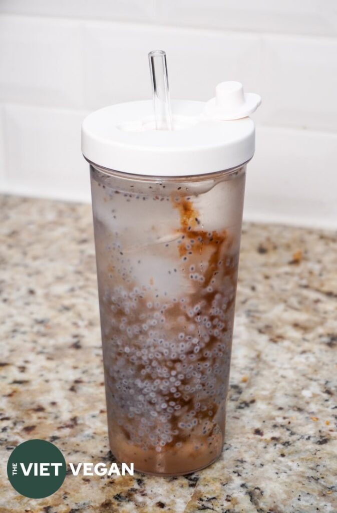 basil seed and malva nut drink in a to go cup on the counter