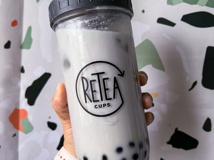 taro milk bubble tea in a reuseable glass in front of a terrazzo background