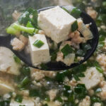 vietnamese tofu and flat chive soup in a ladle