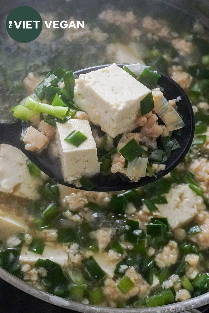 vietnamese tofu and flat chive soup in a ladle