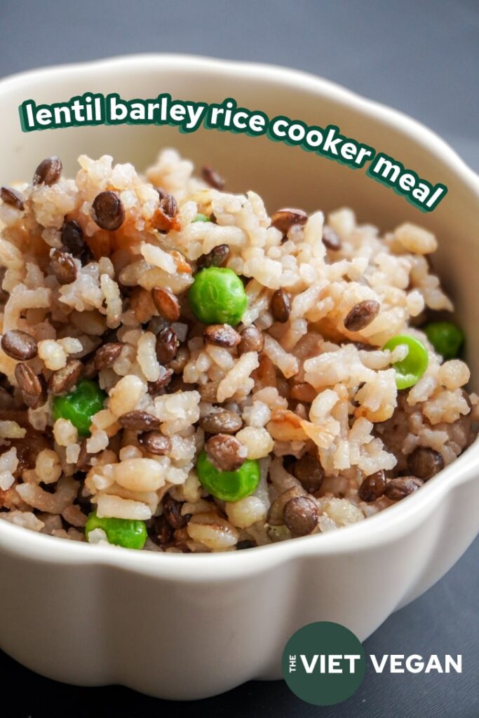 close up of lentil barley rice with peas in a cream scalloped bowl