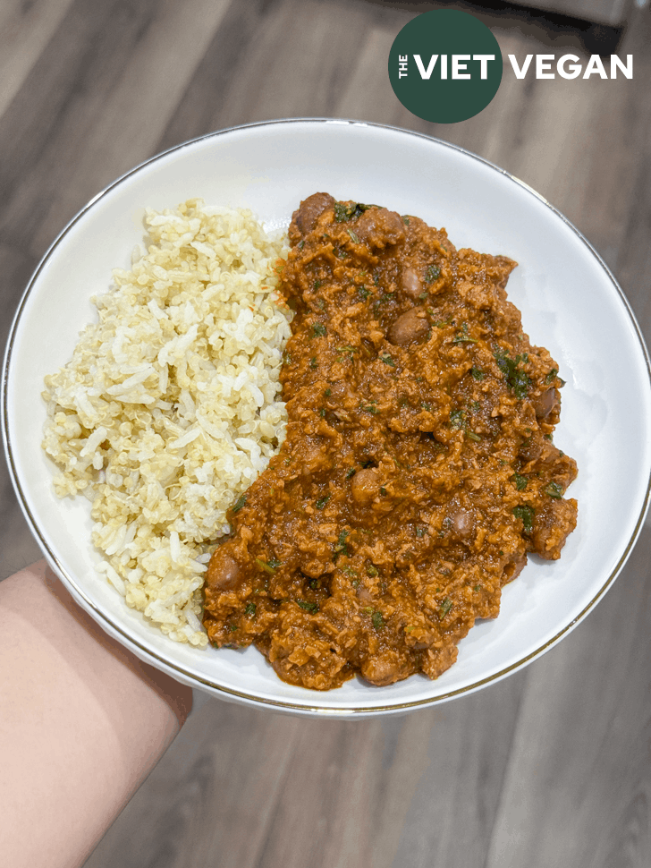 the bell pepper bean stew beside mixed rice in a shallow bowl