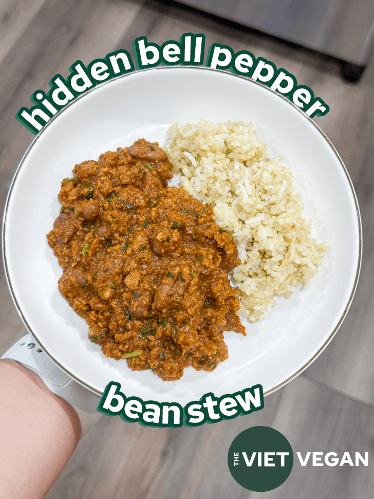 hidden bell pepper stew served with mixed rice in a shallow bowl.